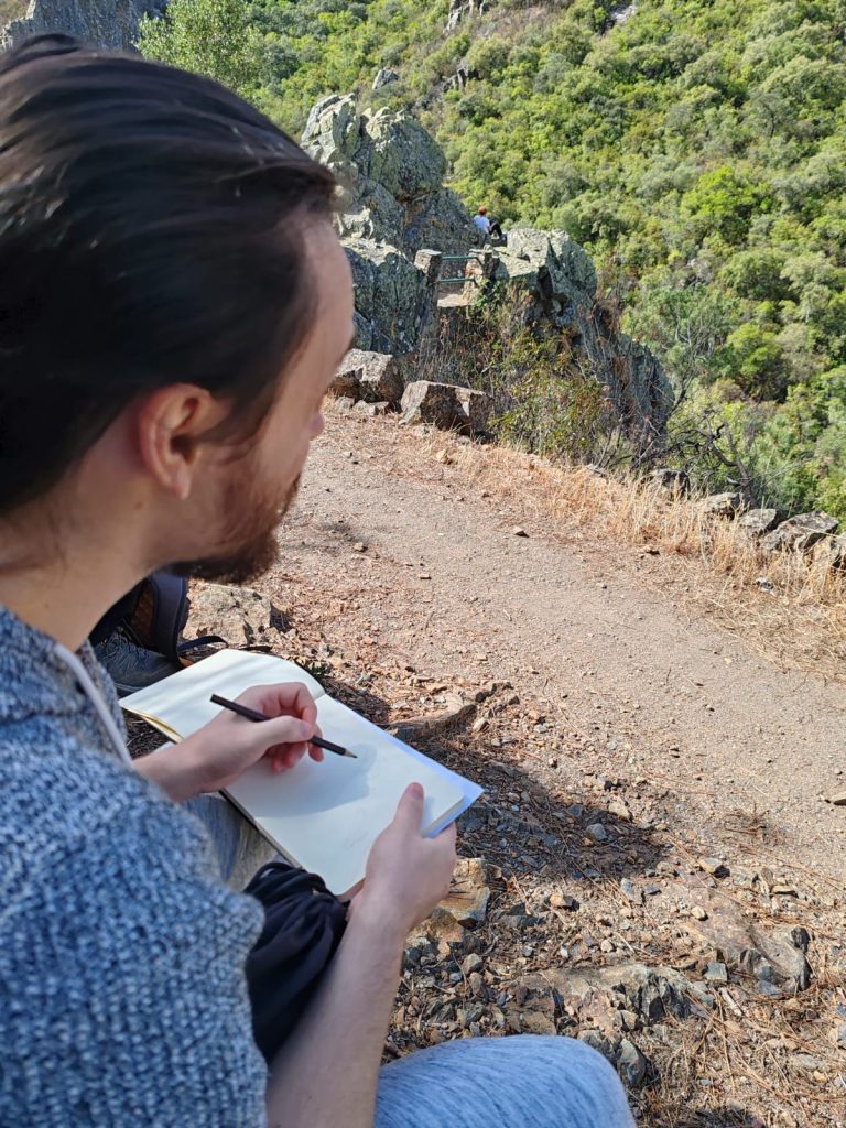 Participante dibujando el mirador de la Georruta de Los Molinos en su cuaderno