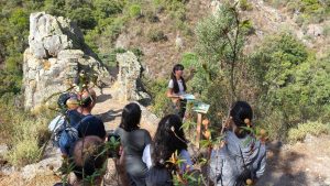 Dr Helena Chacón interprets the landscape from the viewpoint on the Los Molinos GeoTrail, in Alájar